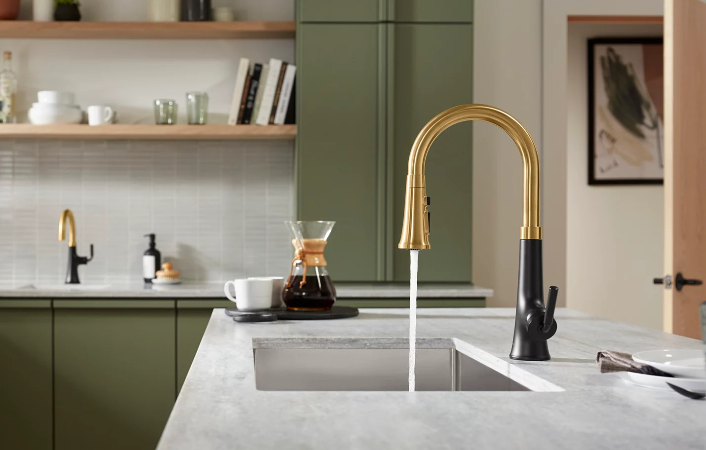Image of a kitchen sink and the faucet is turned on